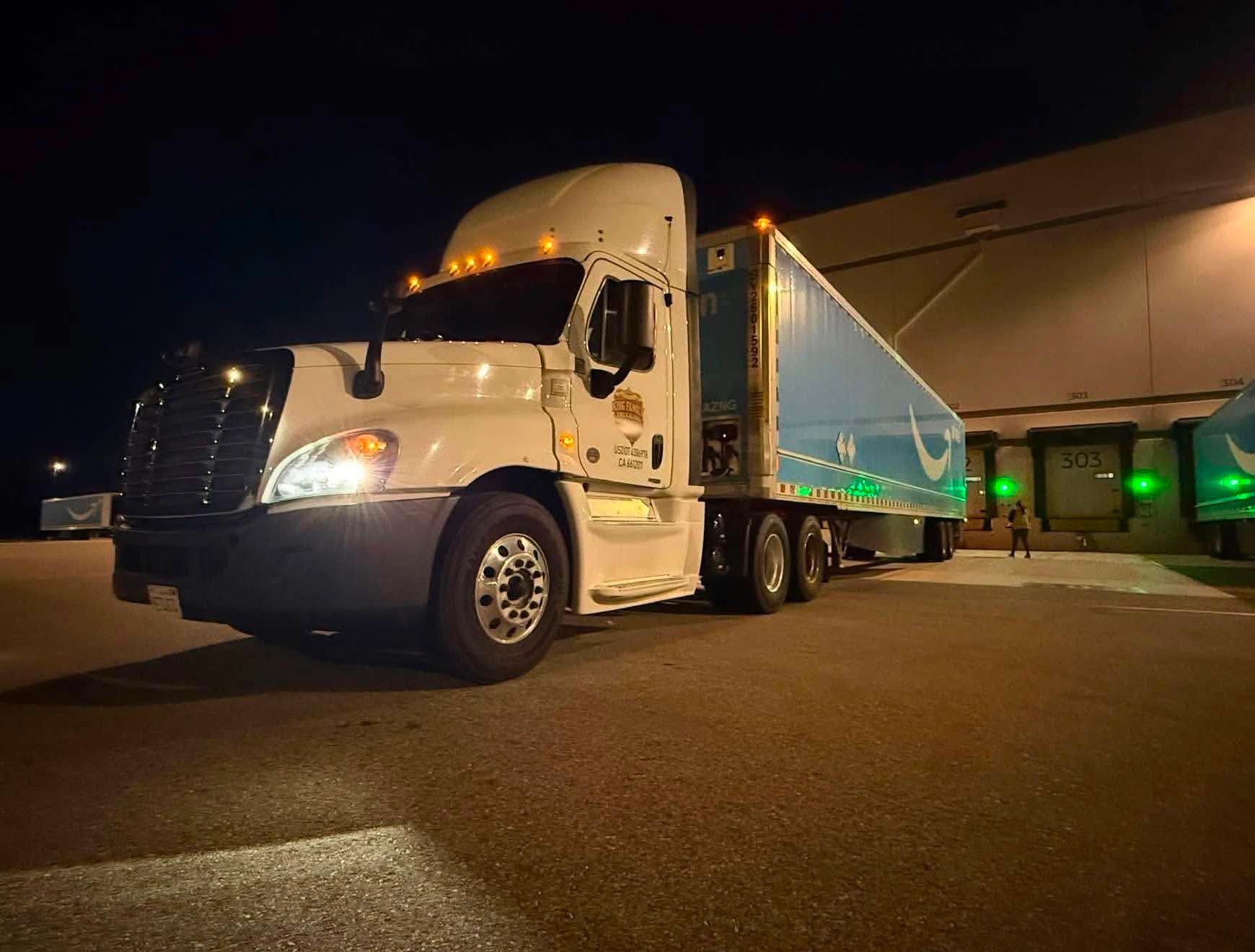 King Family Trucking reefer truck at loading dock at night